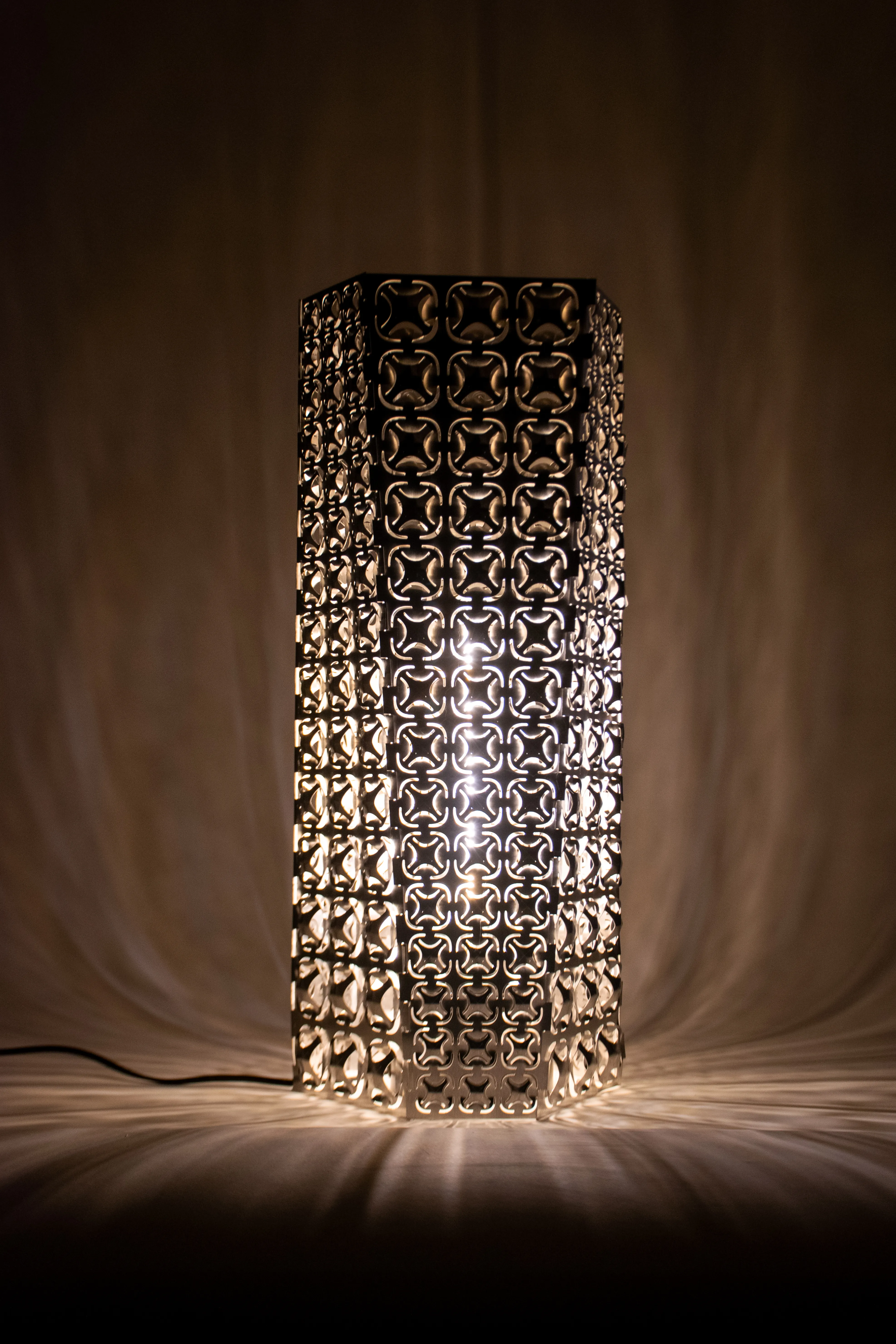 The assembled luminaire casting intricate shadows.