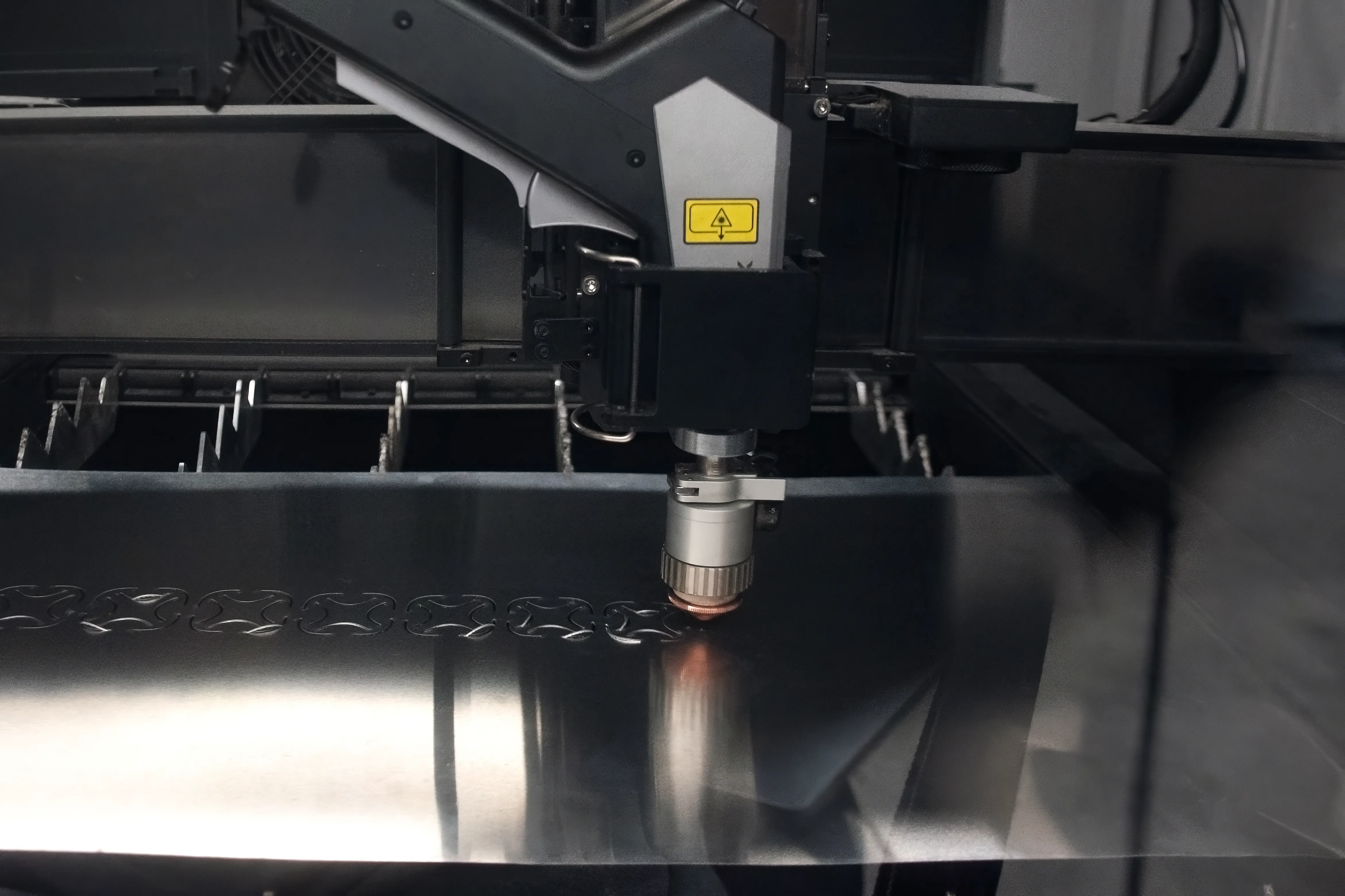 A laser cutter cutting a sheet of aluminum.